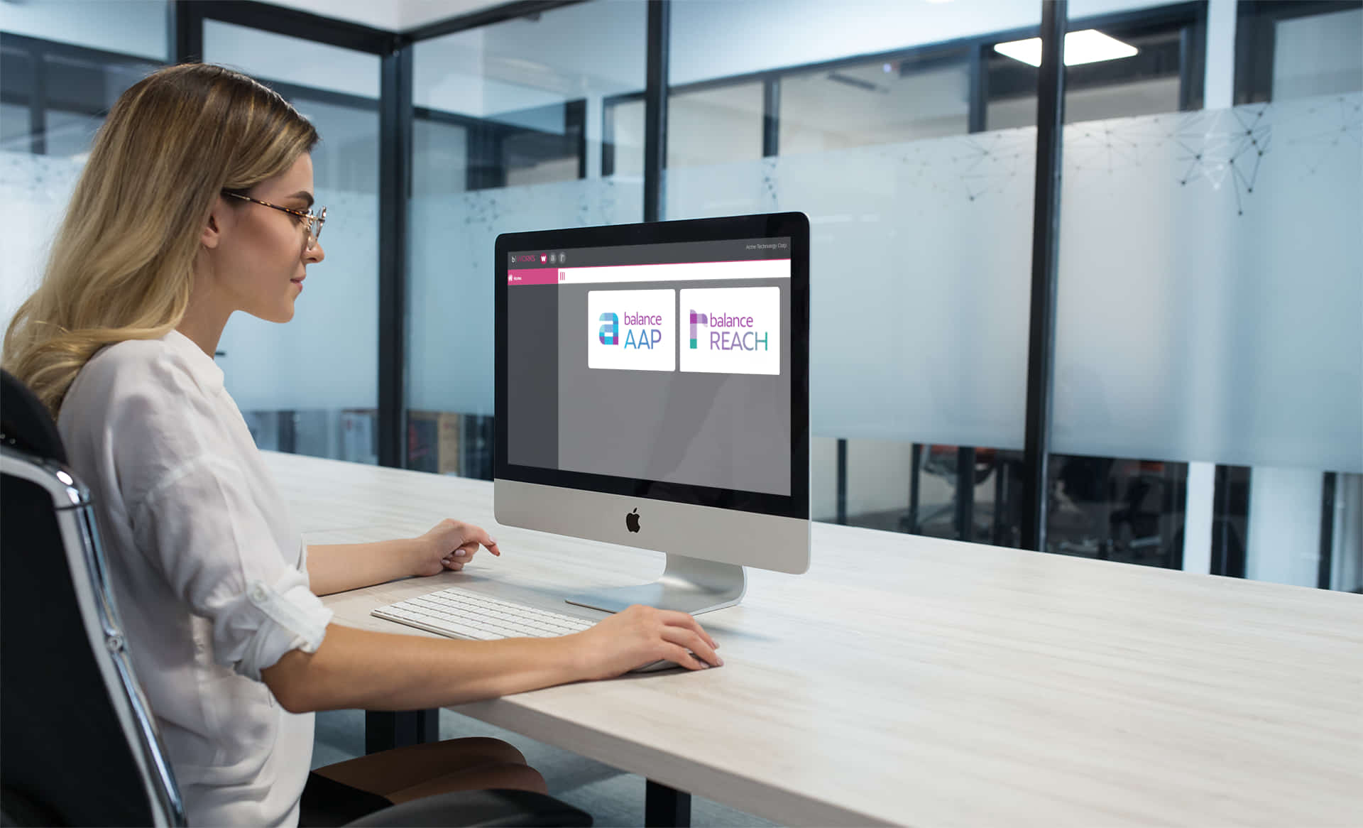 SIZED_blonde-woman-using-an-imac-mockup-at-the-office-a20969 (1)