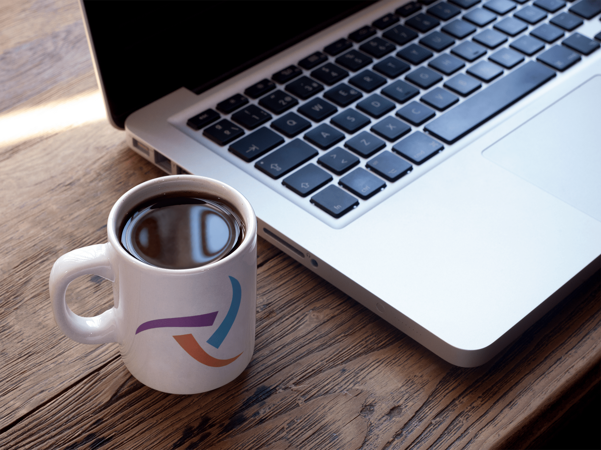 cup-of-coffee-mockup-near-a-macbook-a16461